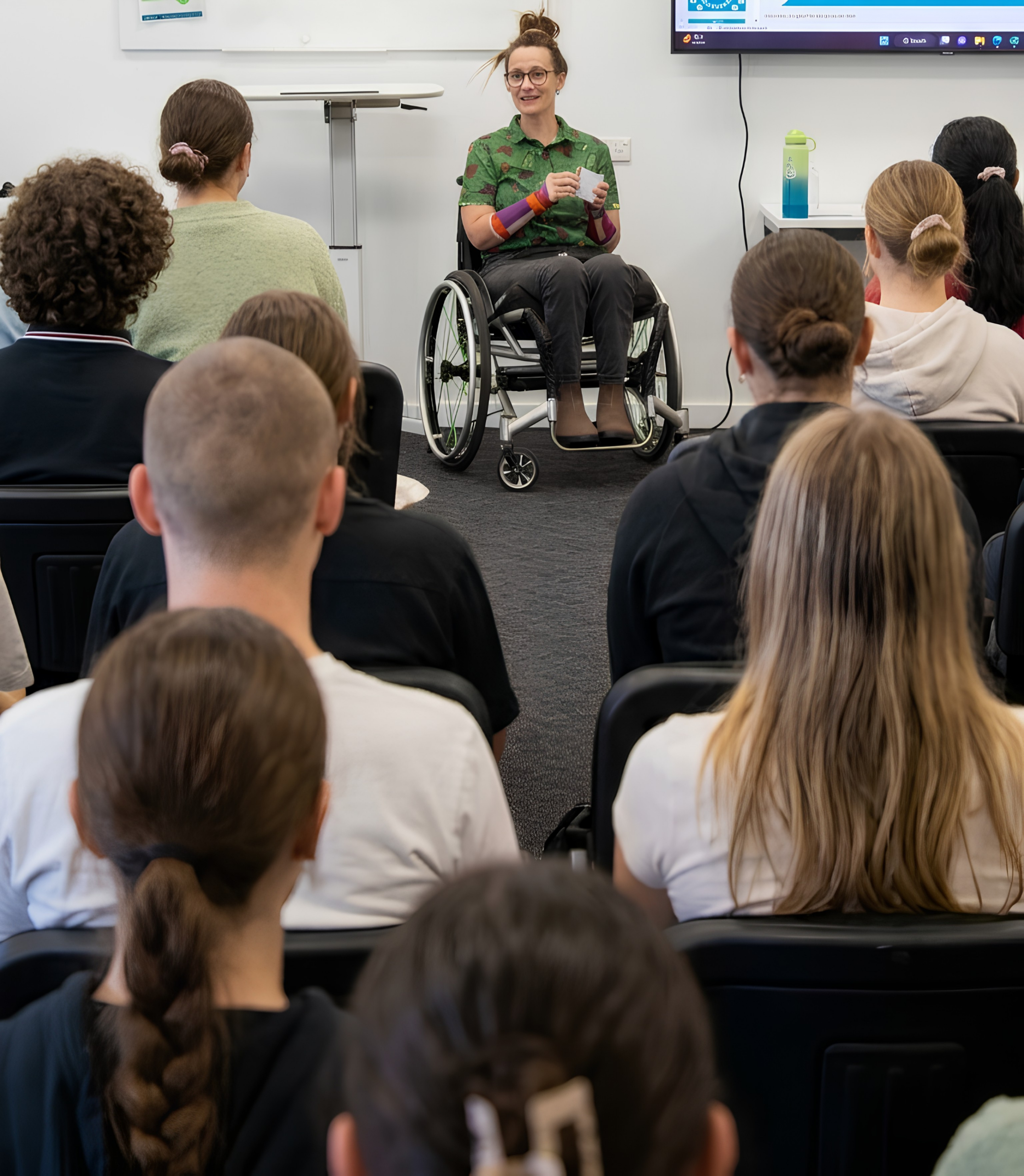 Lived experienced speaker addressing a room of students